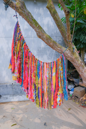 Colorful Saree Wall Hanging made from long strips of vibrant saree fabric, expertly crafted to bring a burst of color and charm to your space.