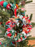 Small saree wreath ornament made from colorful hand tied saree fabric scraps, perfect for adding a vibrant and eco-friendly touch to holiday or home decor.