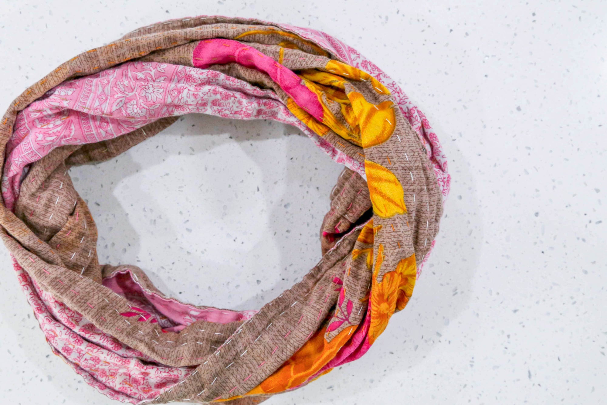 Handmade Kantha infinity scarf with vibrant stitching and beautiful saree patterns, offering a stylish and cozy accessory for year-round wear.