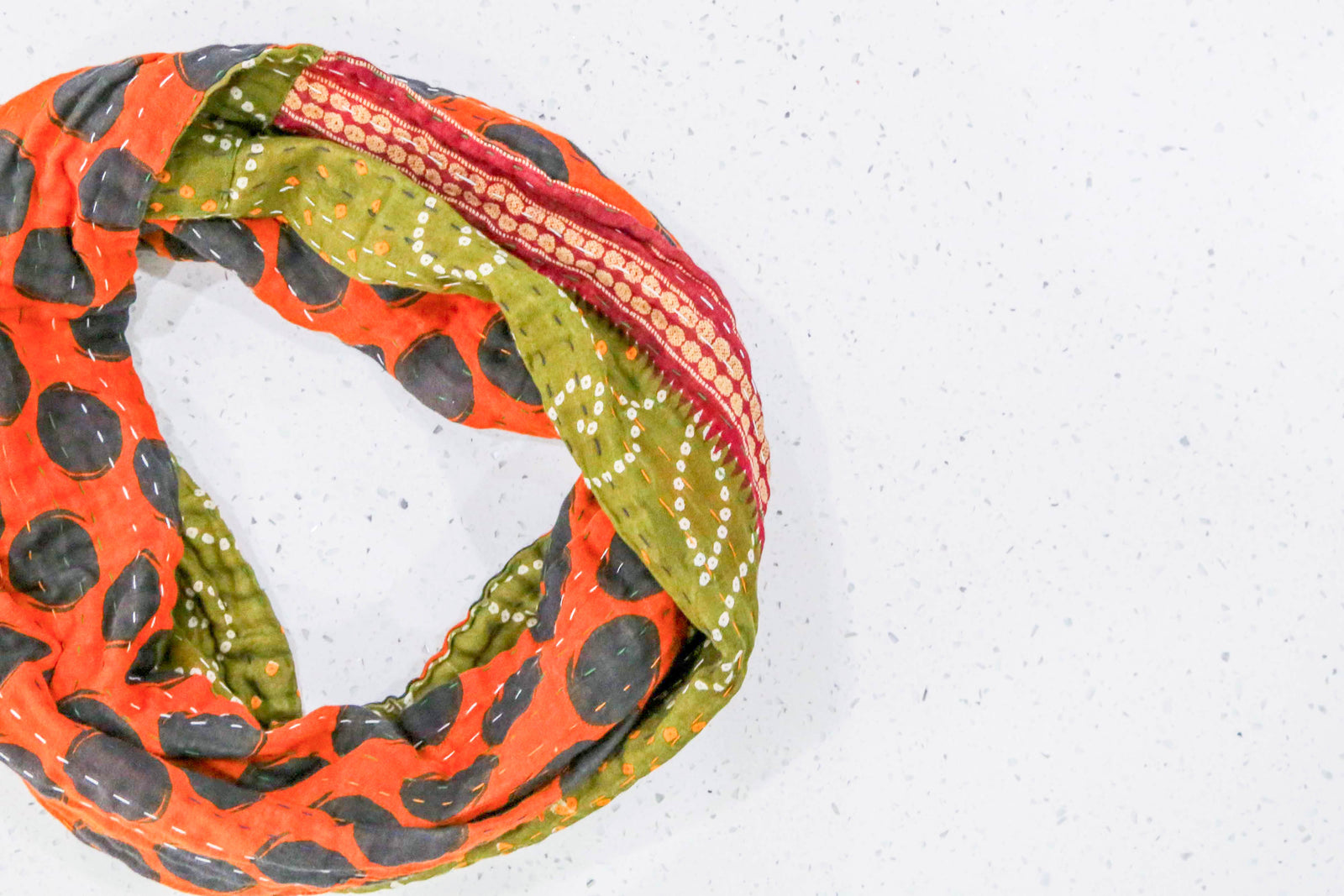 Handmade Kantha infinity scarf with vibrant stitching and beautiful saree patterns, offering a stylish and cozy accessory for year-round wear.