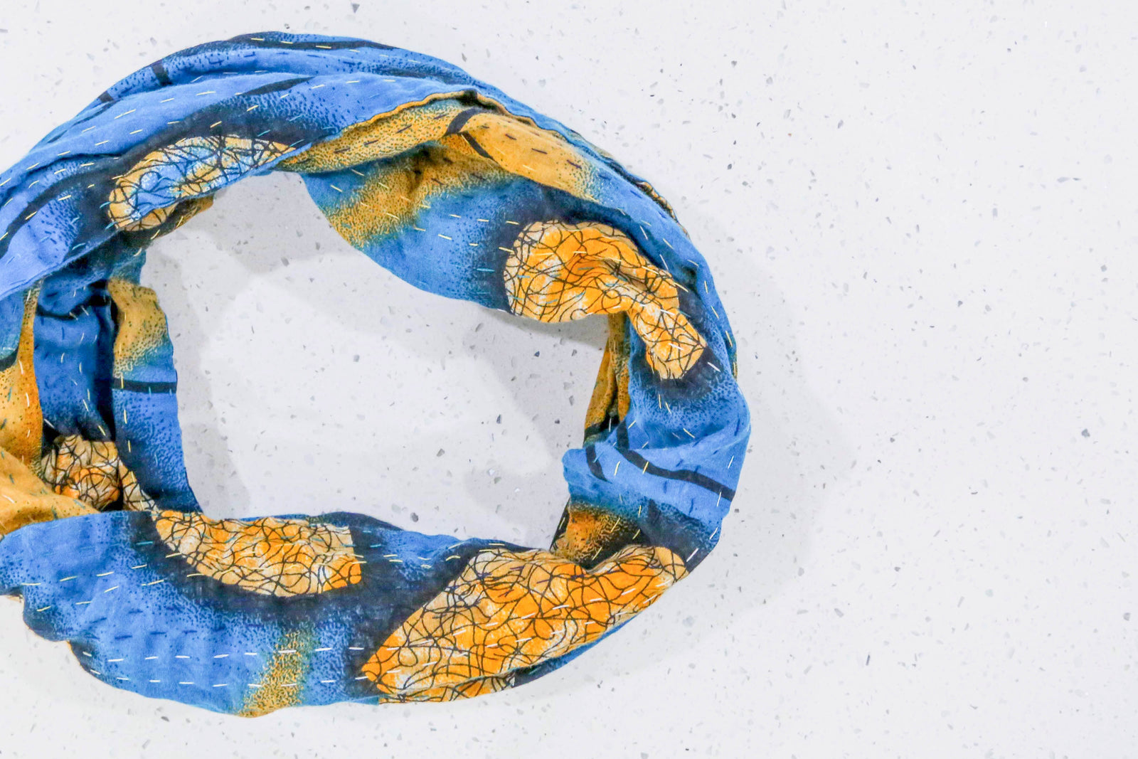 Handmade Kantha infinity scarf with vibrant stitching and beautiful saree patterns, offering a stylish and cozy accessory for year-round wear.