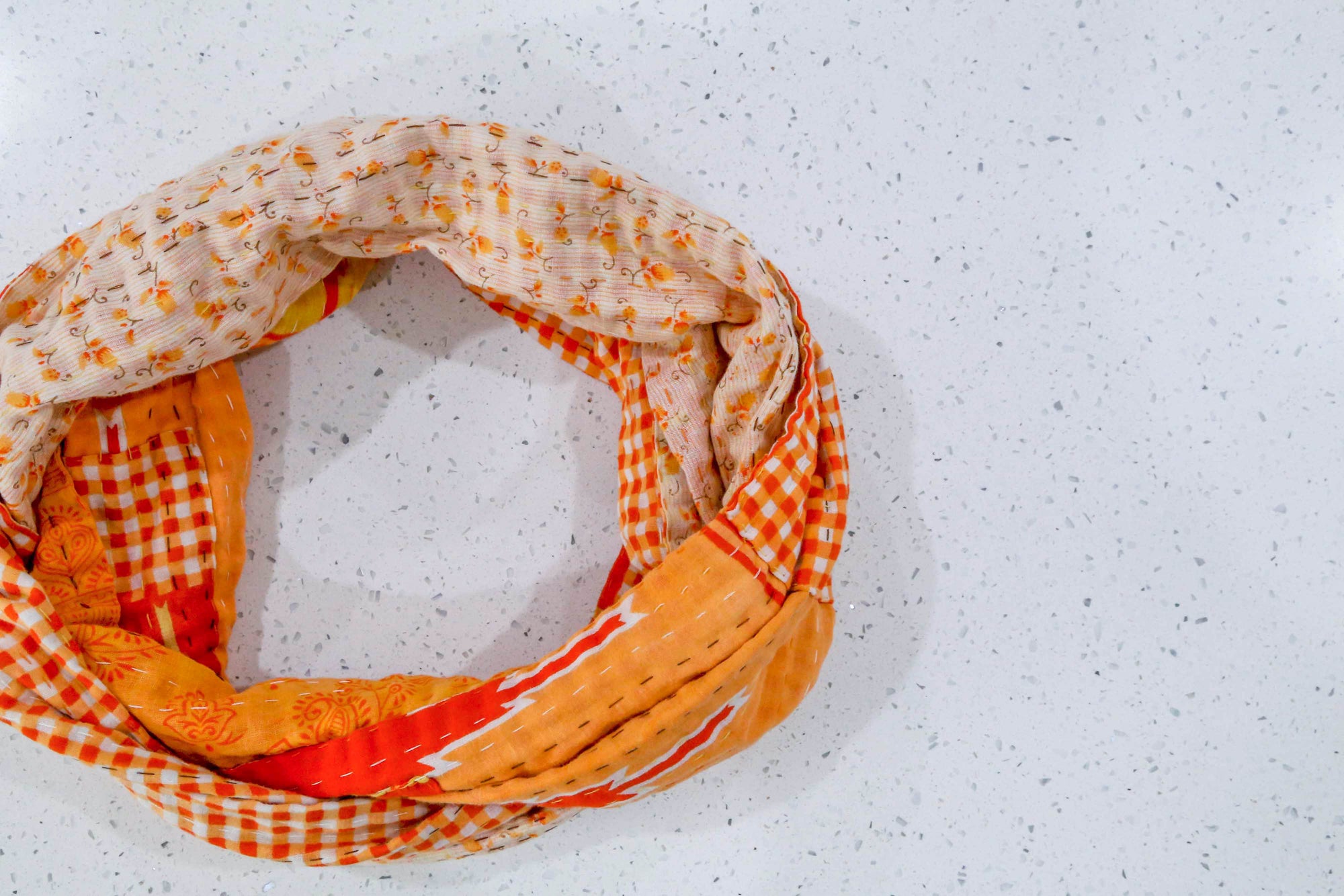 Handmade Kantha infinity scarf with vibrant stitching and beautiful saree patterns, offering a stylish and cozy accessory for year-round wear.
