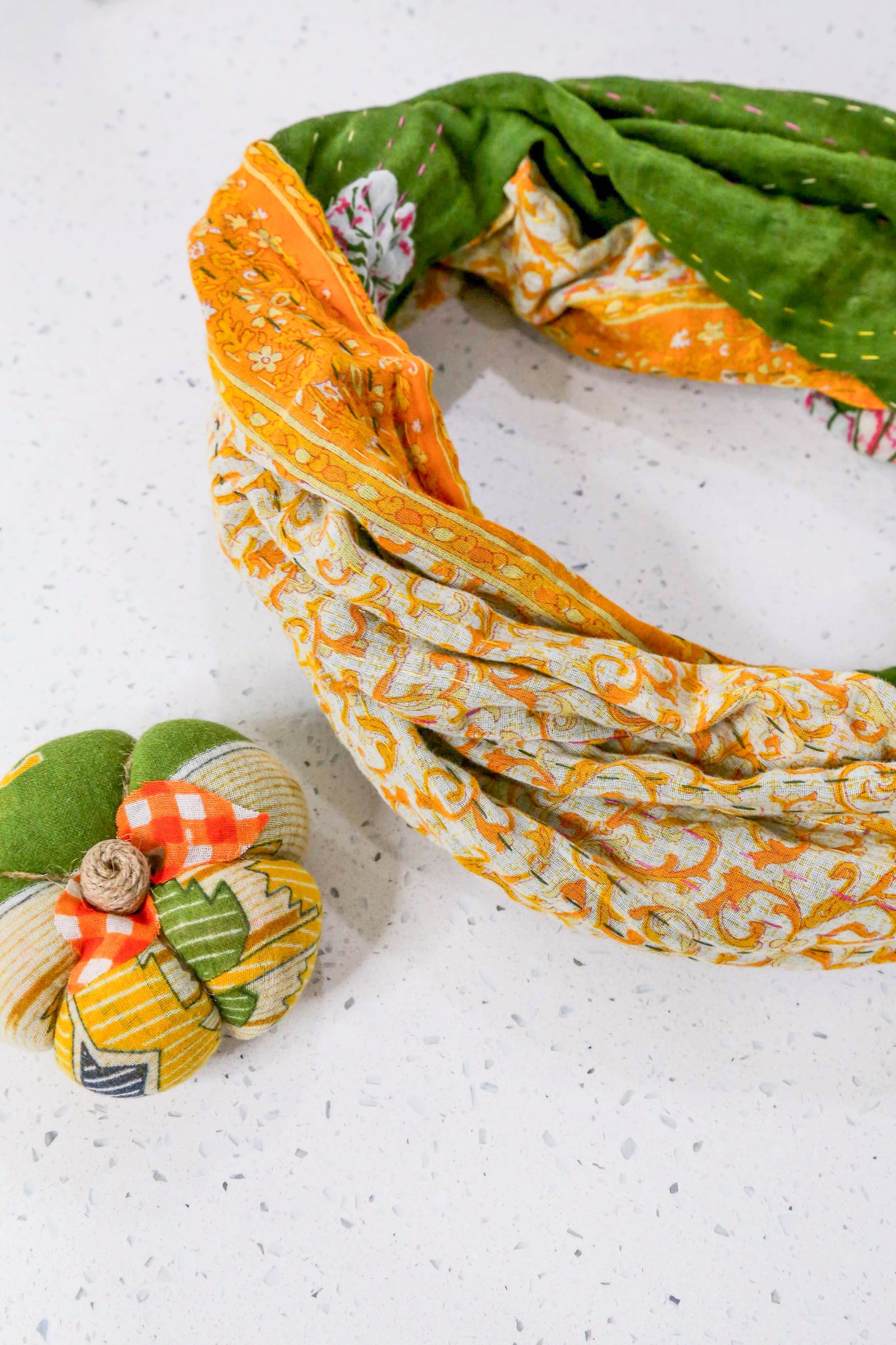Hand-stitched Kantha Infinity Scarf made from recycled cotton sarees, featuring vibrant patchwork patterns and unique stitching.