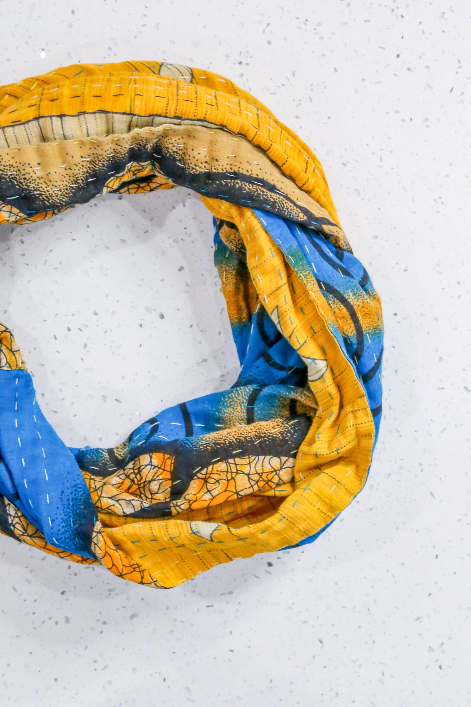 Handmade Kantha infinity scarf with vibrant stitching and beautiful saree patterns, offering a stylish and cozy accessory for year-round wear.