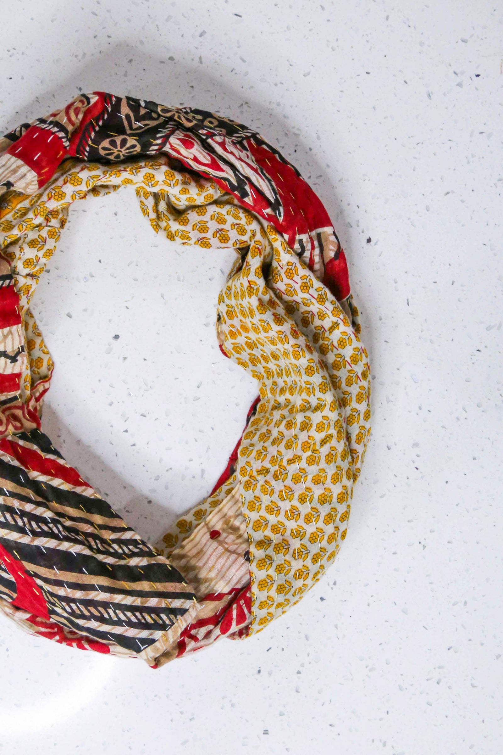 Handmade Kantha infinity scarf with vibrant stitching and beautiful saree patterns, offering a stylish and cozy accessory for year-round wear.