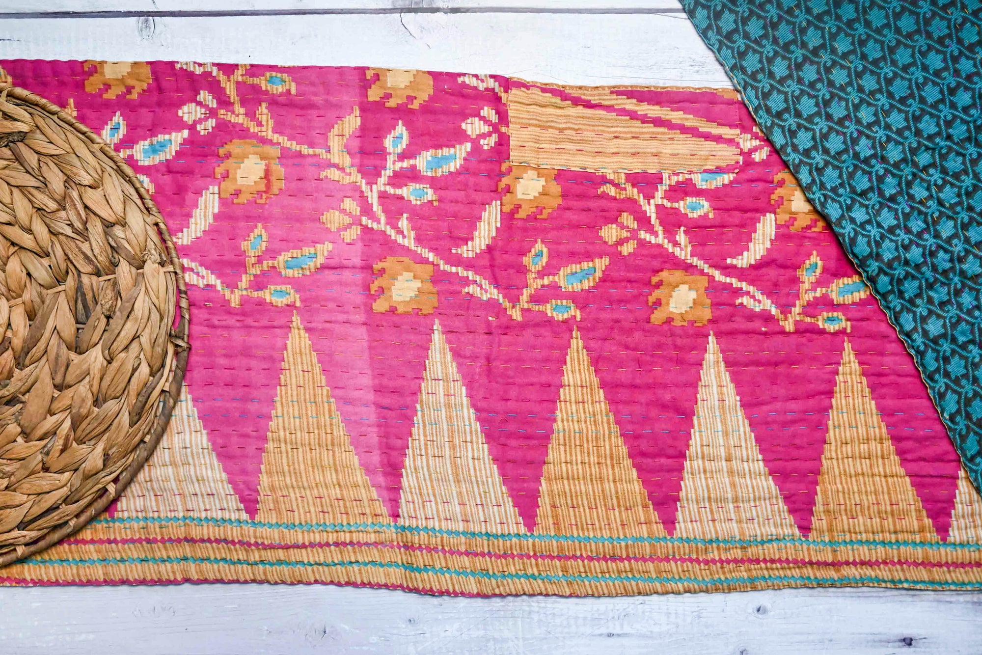 Pink and tan floral with the reverse side blue and black damask style. Handmade Kantha table runner with vibrant, stitched patterns, adding a colorful and textured touch to your dining or coffee table.