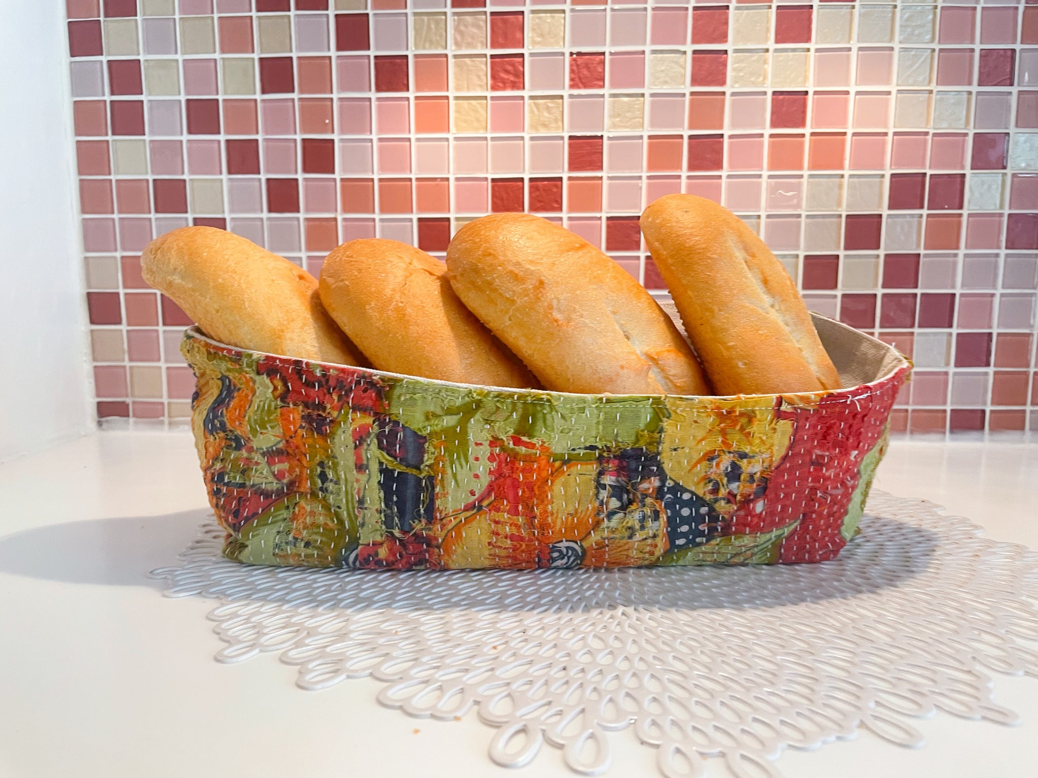 Vintage Kantha bread basket, handcrafted from eco-friendly fabric with vibrant, colorful stitching. The intricate Kantha embroidery features a mix of bold patterns and rich hues, making this basket both a functional and decorative piece. Perfect for serving bread, rolls, or storing small items, it adds a touch of rustic charm and handmade elegance to any kitchen or dining room