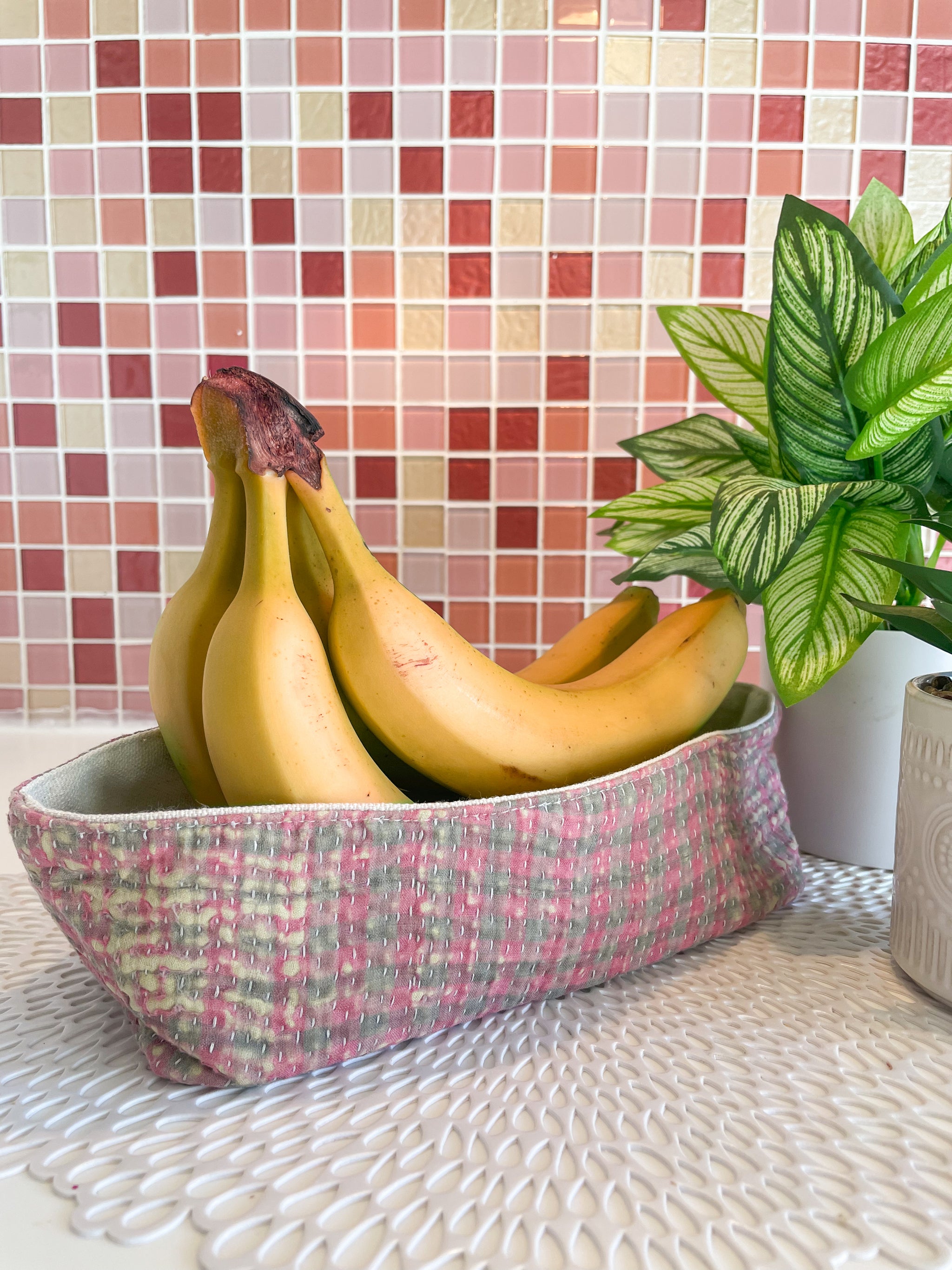 Vintage Kantha bread basket, handcrafted from eco-friendly fabric with vibrant, colorful stitching. The intricate Kantha embroidery features a mix of bold patterns and rich hues, making this basket both a functional and decorative piece. Perfect for serving bread, rolls, or storing small items, it adds a touch of rustic charm and handmade elegance to any kitchen or dining room