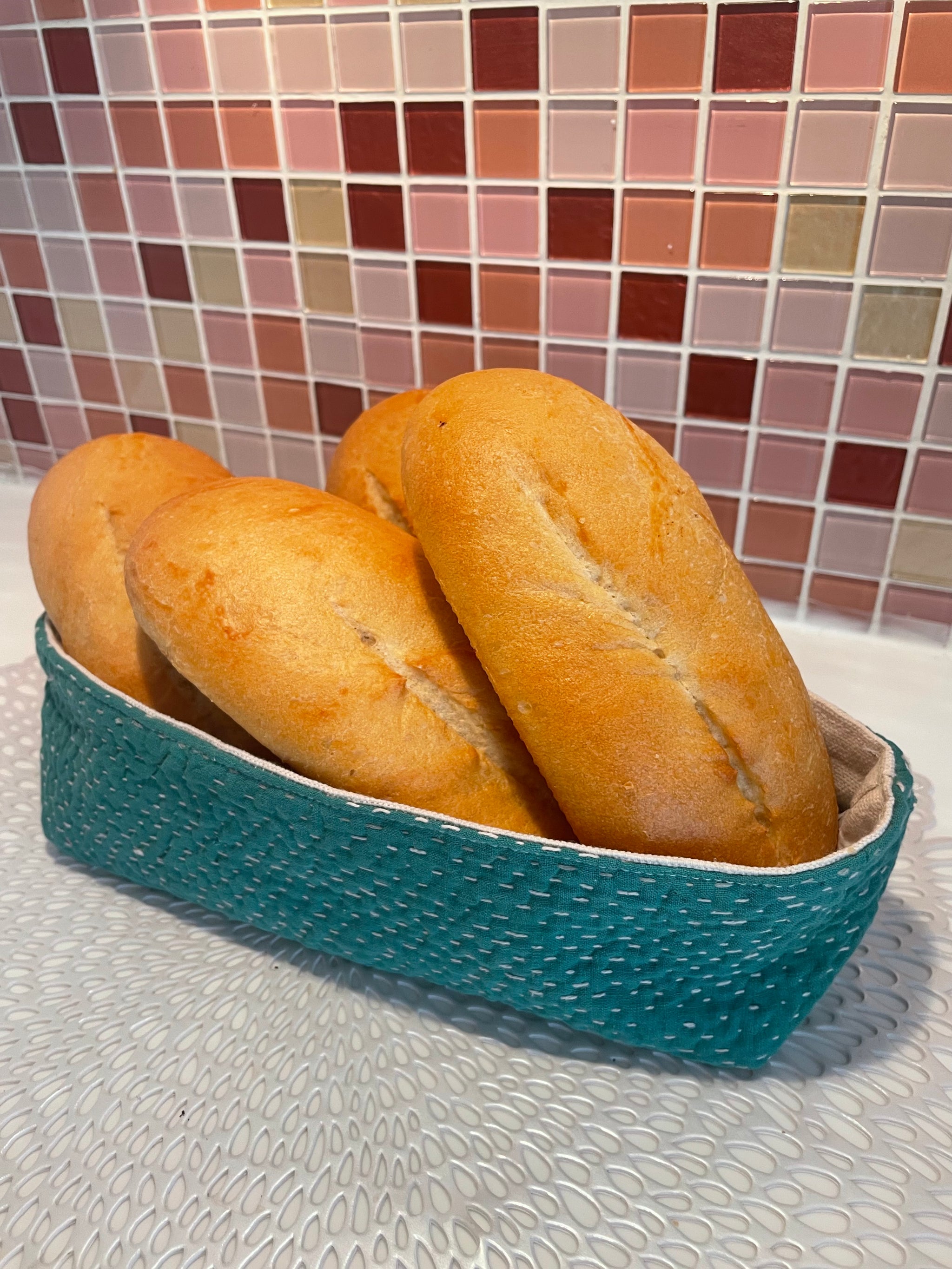 Vintage Kantha bread basket, handcrafted from eco-friendly fabric with vibrant, colorful stitching. The intricate Kantha embroidery features a mix of bold patterns and rich hues, making this basket both a functional and decorative piece. Perfect for serving bread, rolls, or storing small items, it adds a touch of rustic charm and handmade elegance to any kitchen or dining room