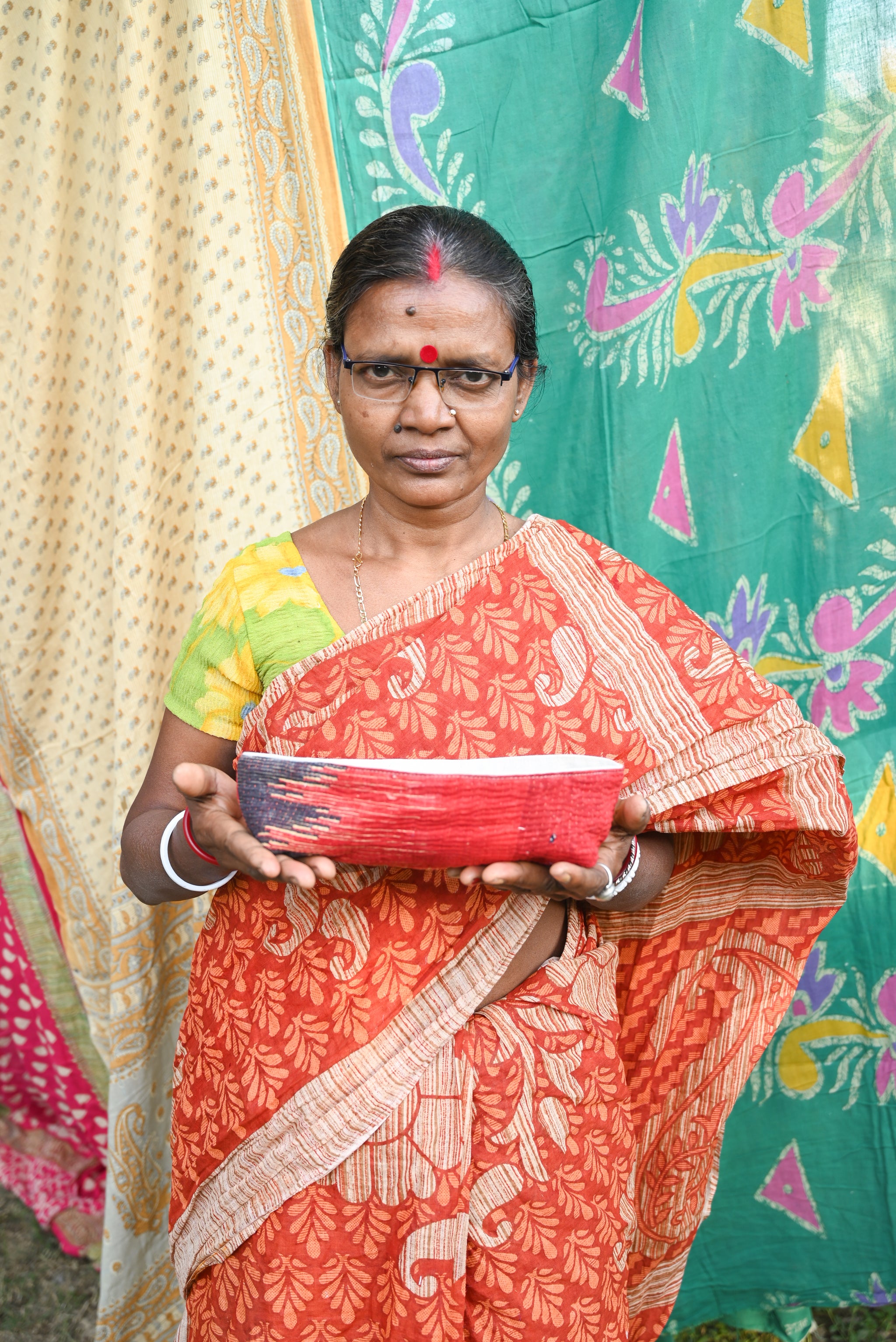 Vintage Kantha bread basket, handcrafted from eco-friendly fabric with vibrant, colorful stitching. The intricate Kantha embroidery features a mix of bold patterns and rich hues, making this basket both a functional and decorative piece. Perfect for serving bread, rolls, or storing small items, it adds a touch of rustic charm and handmade elegance to any kitchen or dining room