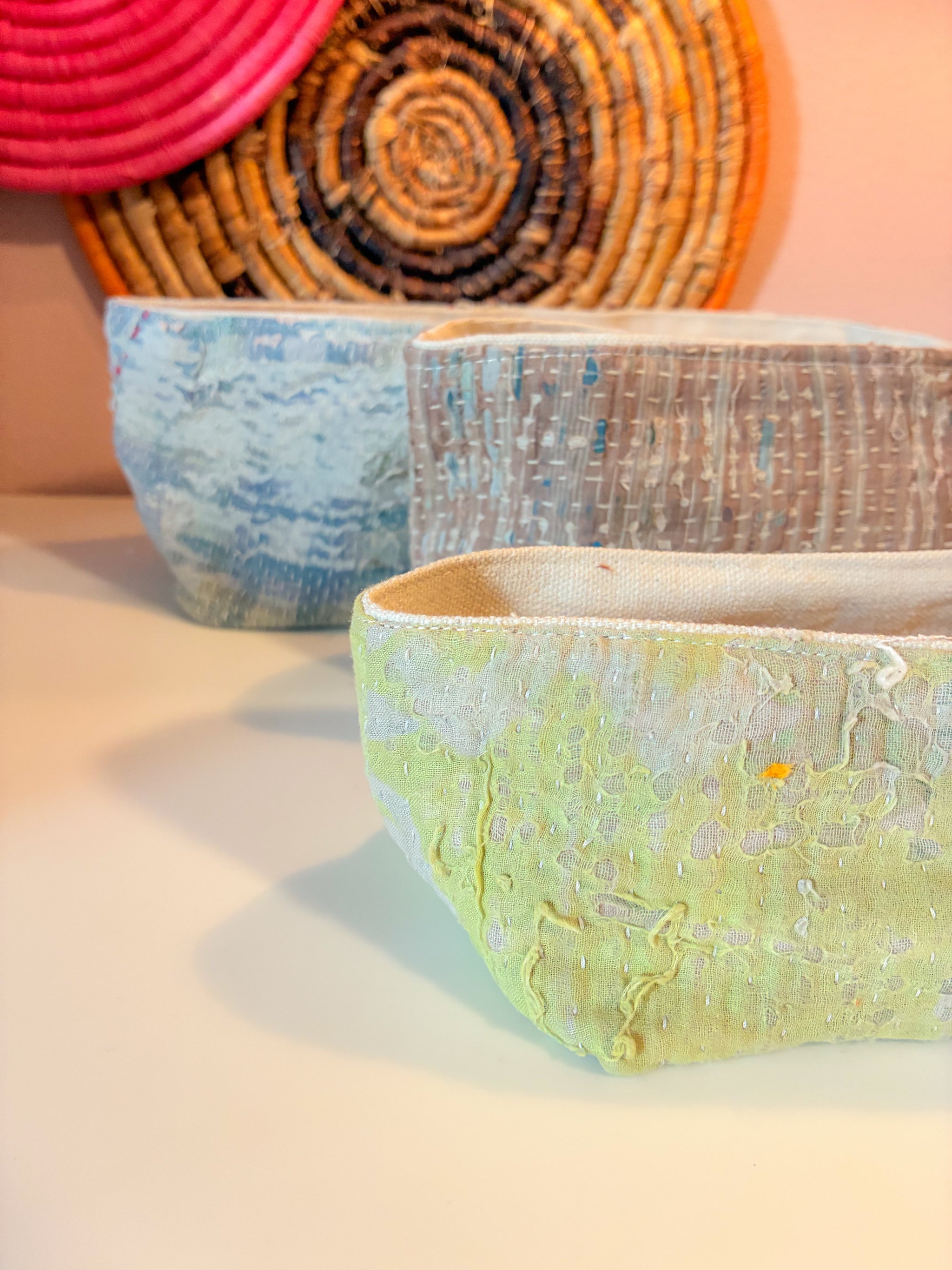 Vintage Kantha bread basket, handcrafted from eco-friendly fabric with vibrant, colorful stitching. The intricate Kantha embroidery features a mix of bold patterns and rich hues, making this basket both a functional and decorative piece. Perfect for serving bread, rolls, or storing small items, it adds a touch of rustic charm and handmade elegance to any kitchen or dining room