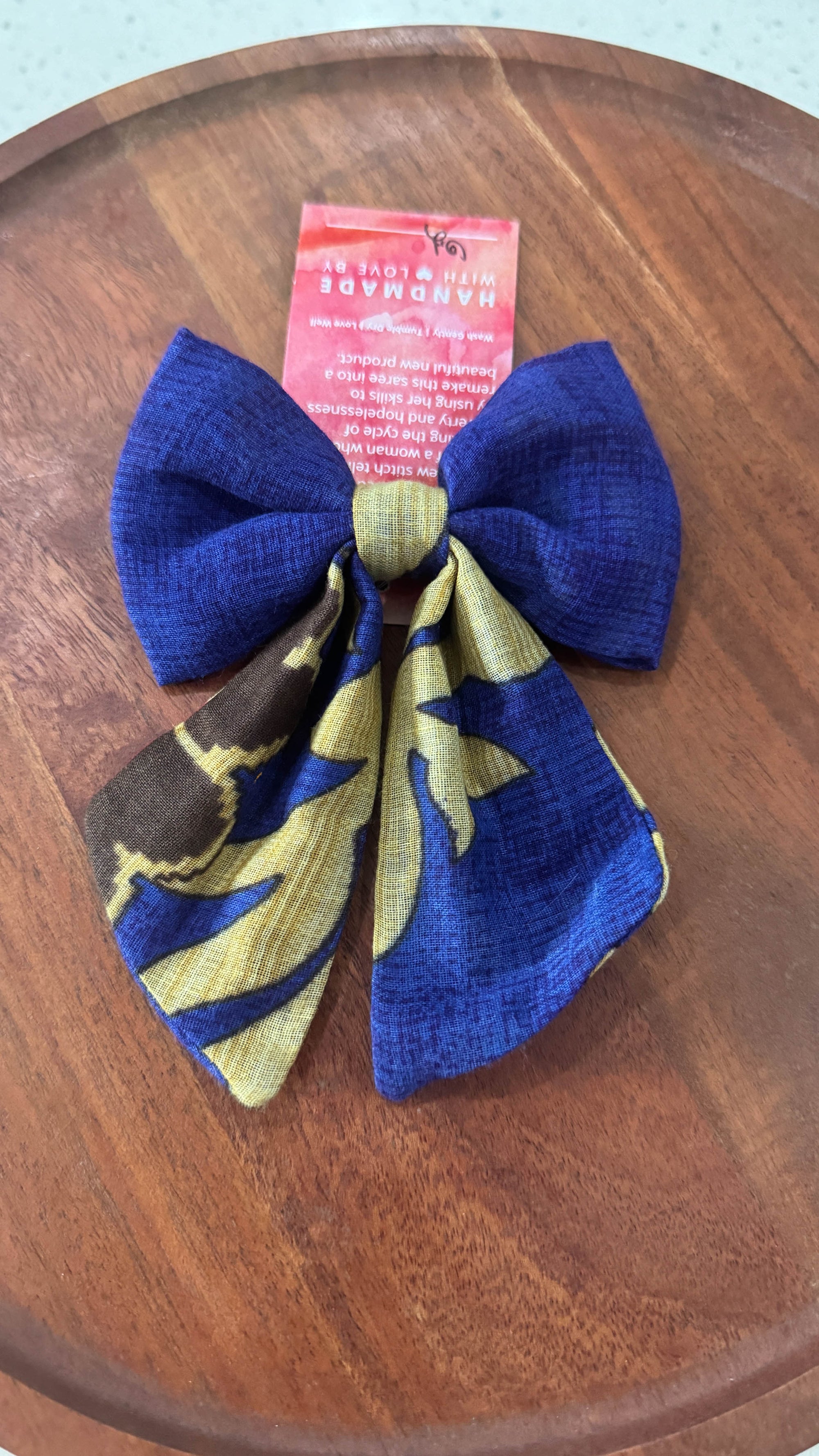 a wooden table with a blue and yellow bow on it