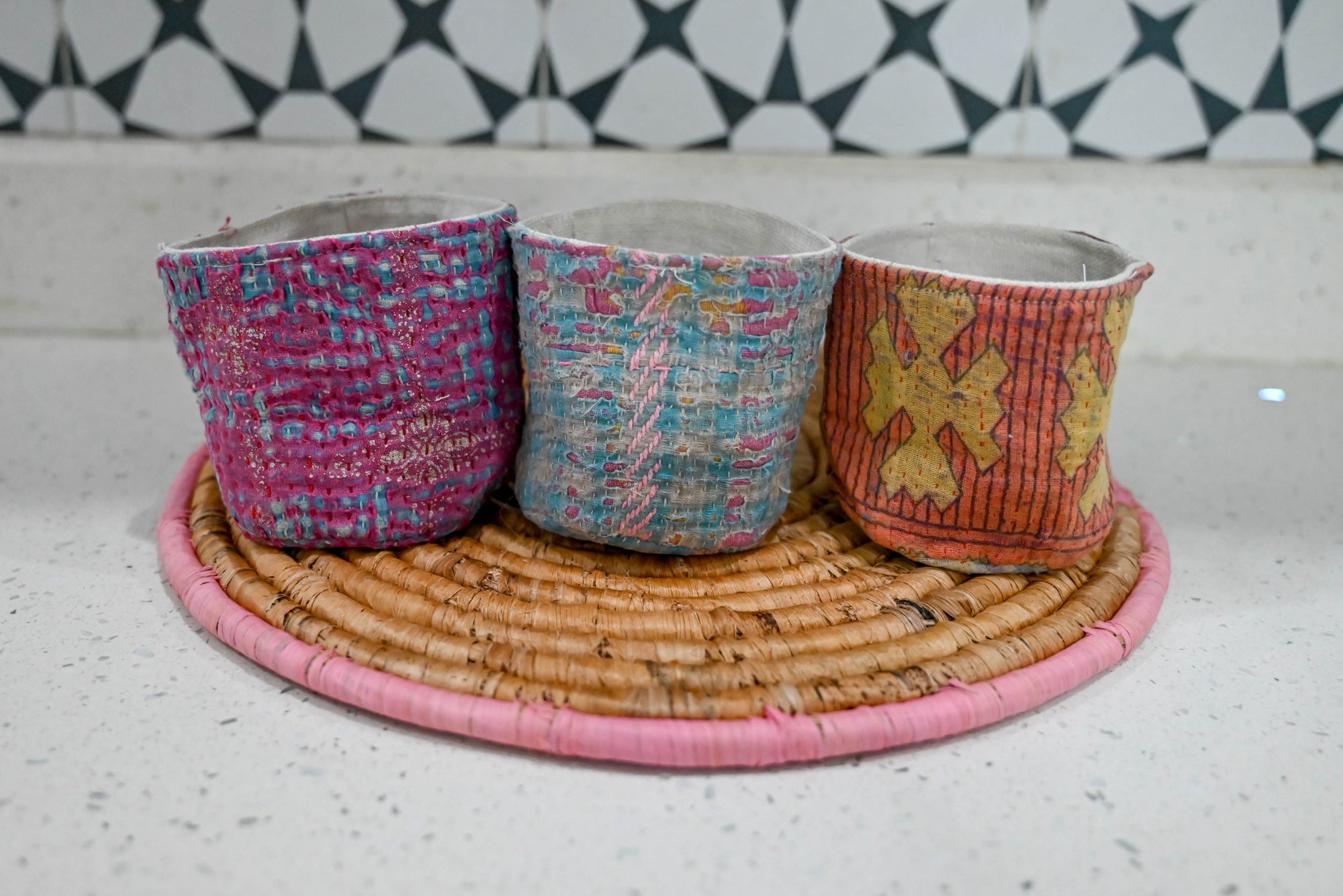 three cups sitting on top of a wicker tray