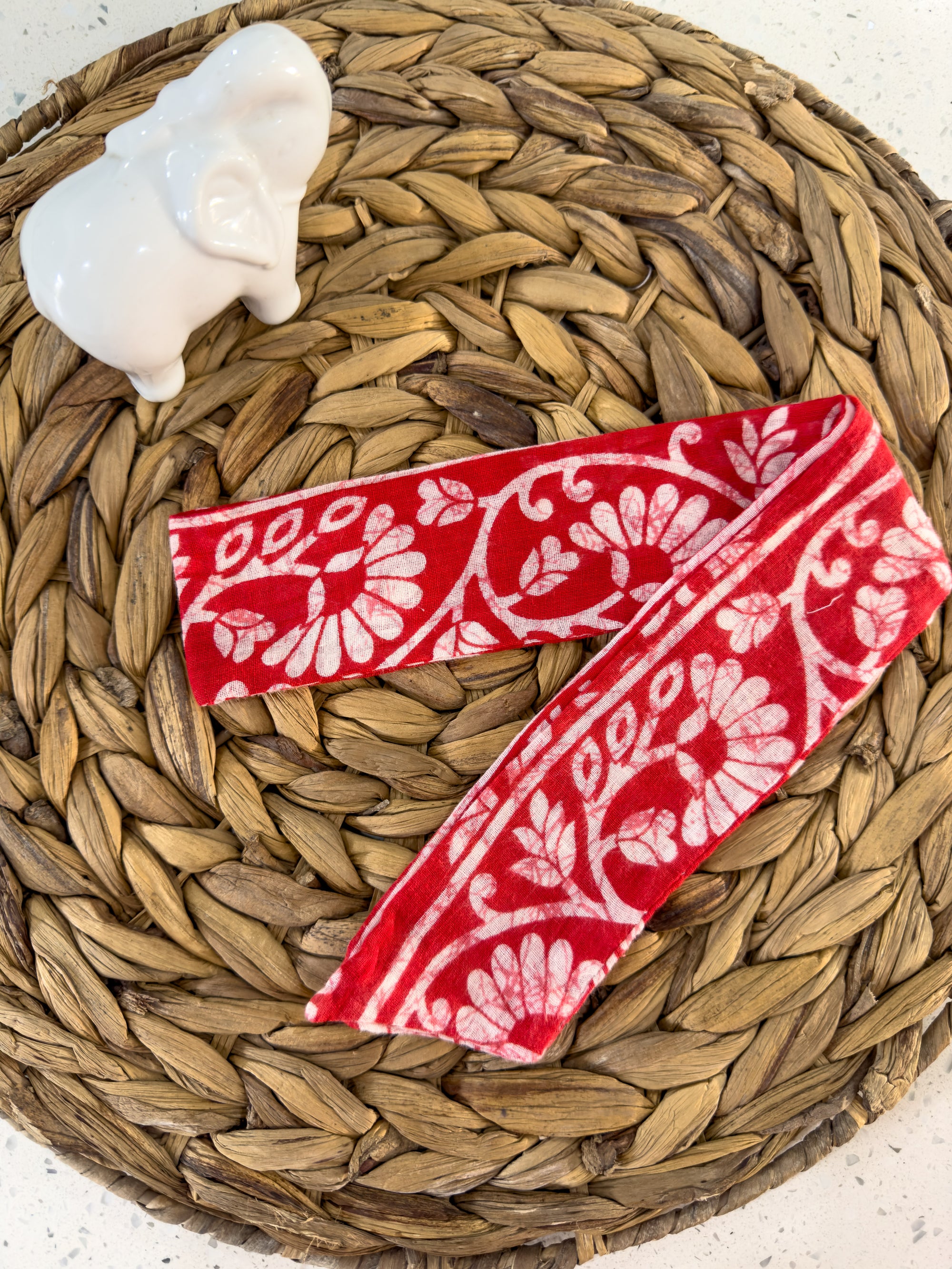 a red and white ribbon sitting on top of a basket