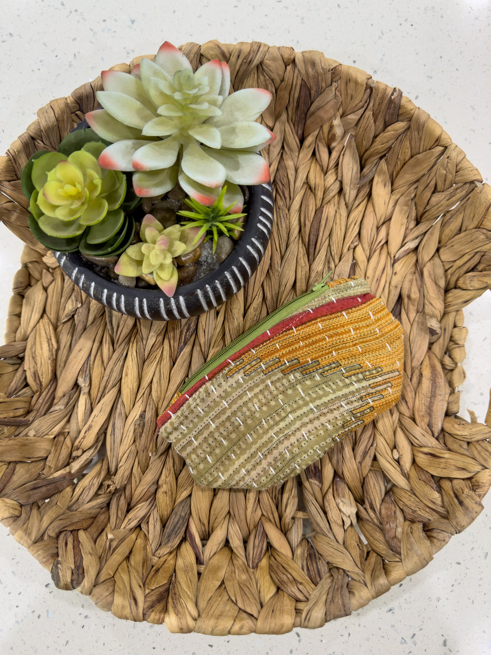 a basket with a flower and a plant in it