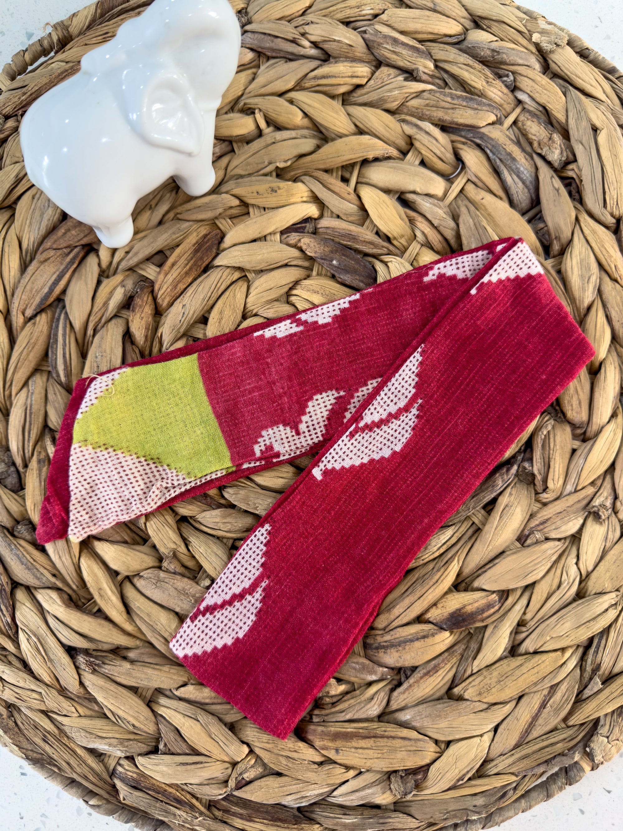 a pair of red socks sitting on top of a woven basket