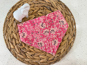 a pink bandana with a pink flower pattern on it