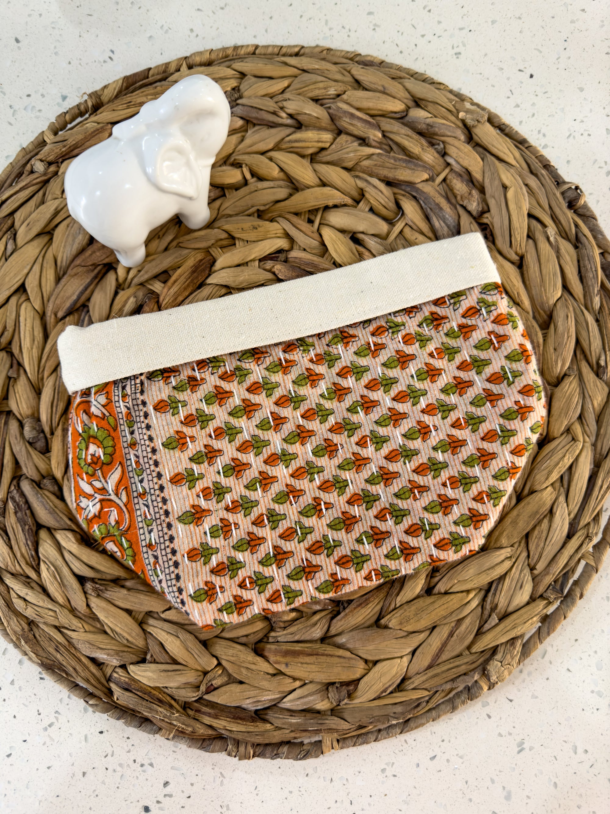 a small purse sitting on top of a wicker basket
