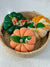 a basket filled with decorative pumpkins on top of a table