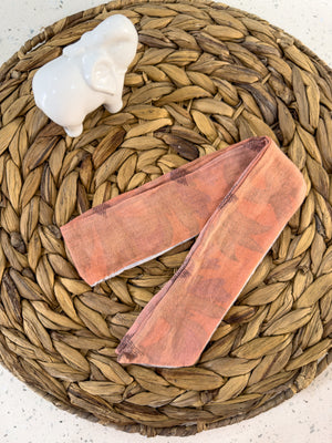 a basket with a pair of pink leggings and a white elephant figuri