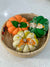a basket filled with fabric pumpkins sitting on top of a table