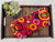 a pair of red and yellow polka dots on a wooden tray with succulent