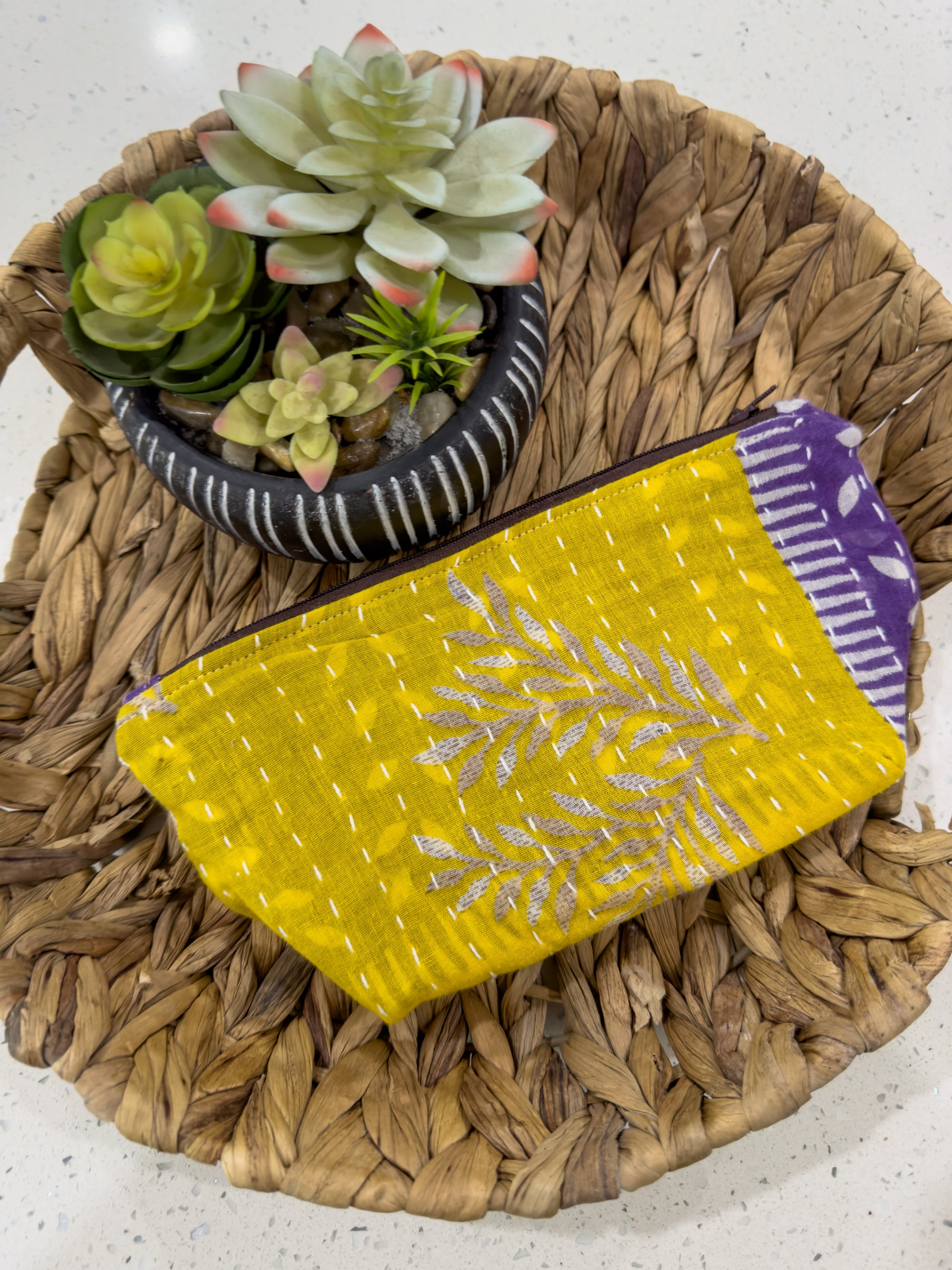 a yellow purse sitting on top of a woven basket