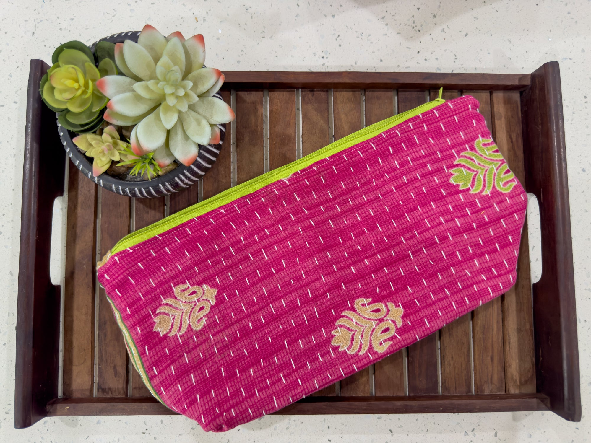 a pink bag sitting on top of a wooden tray