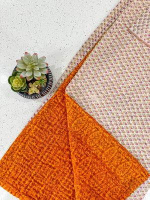 a close up of a piece of cloth next to a potted plant