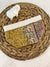 a woven basket with a small piece of cloth on top of it