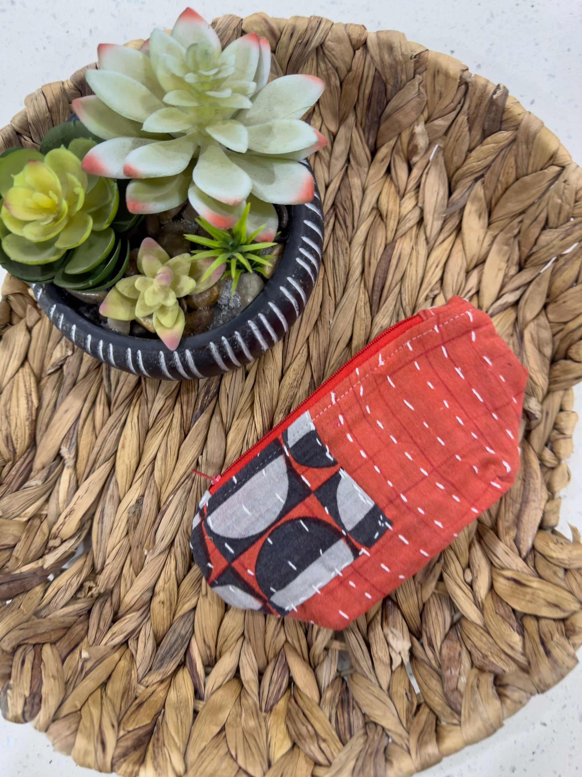 a small potted plant sitting on top of a woven tray