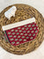 a red and white tie sitting on top of a basket