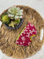 a bowl of succulents sits on a woven tray