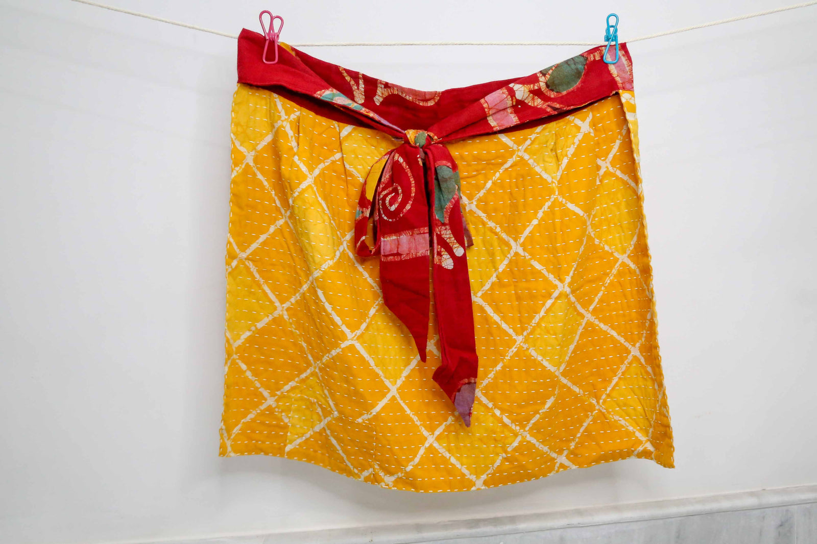 Handmade Kantha half apron with intricate stitching and vibrant fabric patterns, perfect for adding a touch of traditional style to your kitchen while cooking or crafting.