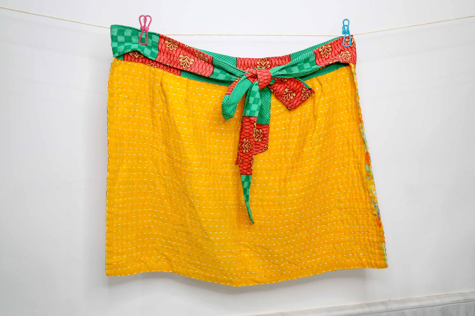 Handmade Kantha half apron with intricate stitching and vibrant fabric patterns, perfect for adding a touch of traditional style to your kitchen while cooking or crafting.