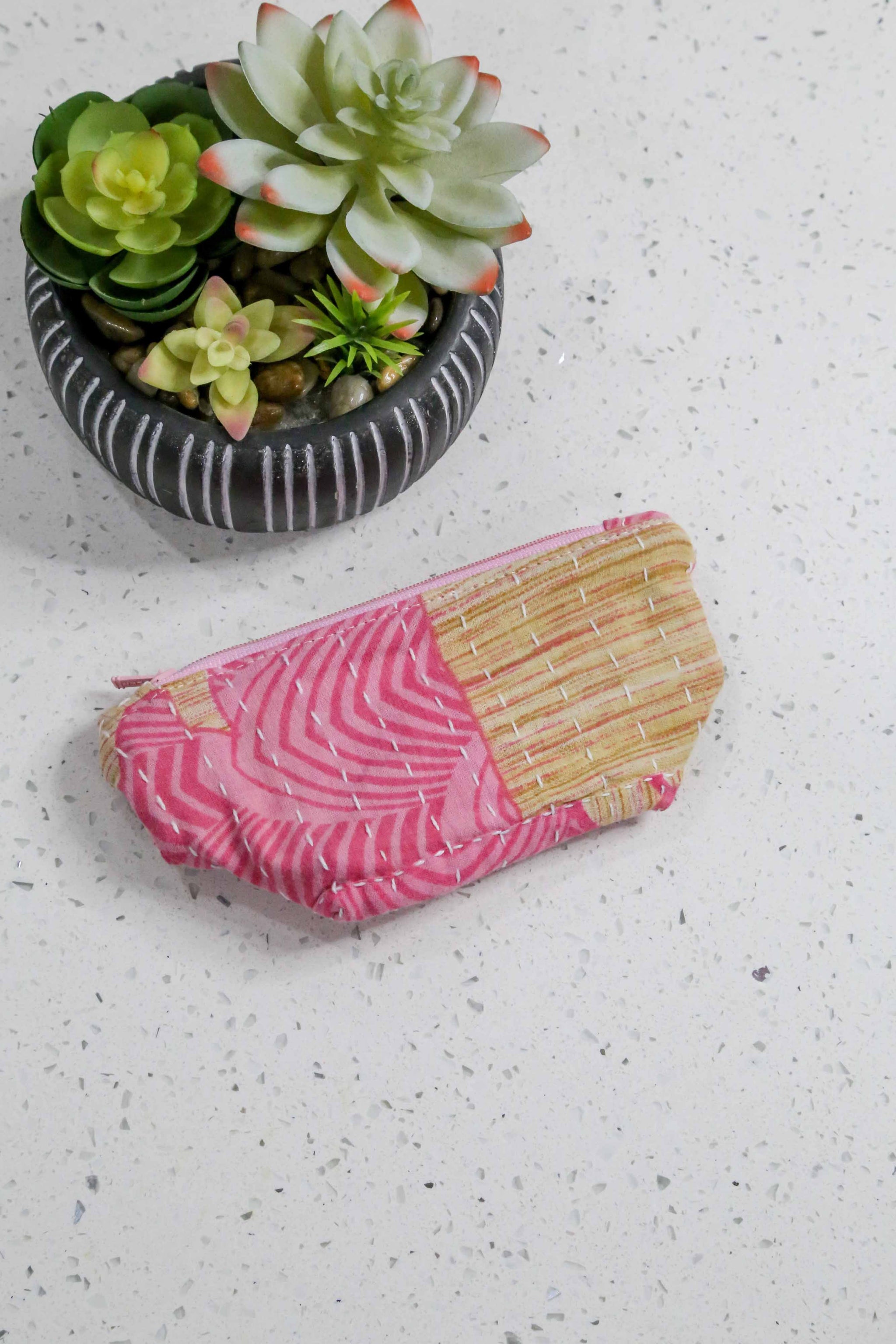 Handmade small Kantha cosmetic bag with vibrant saree patterns, perfect for fitting all your to-go items in one stylish, spacious bag for travel or daily use.