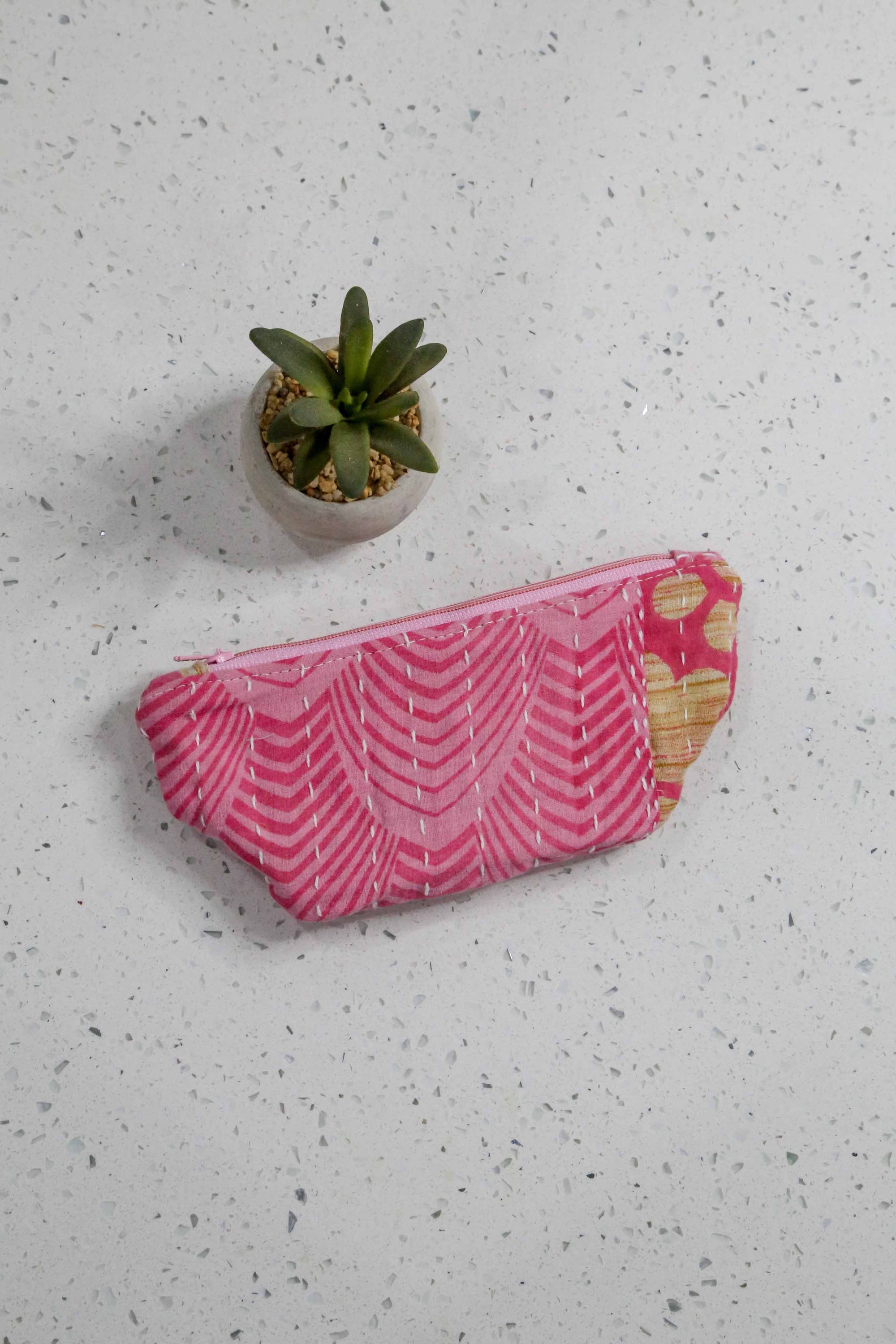 Handmade small Kantha cosmetic bag with vibrant saree patterns, perfect for fitting all your to-go items in one stylish, spacious bag for travel or daily use.