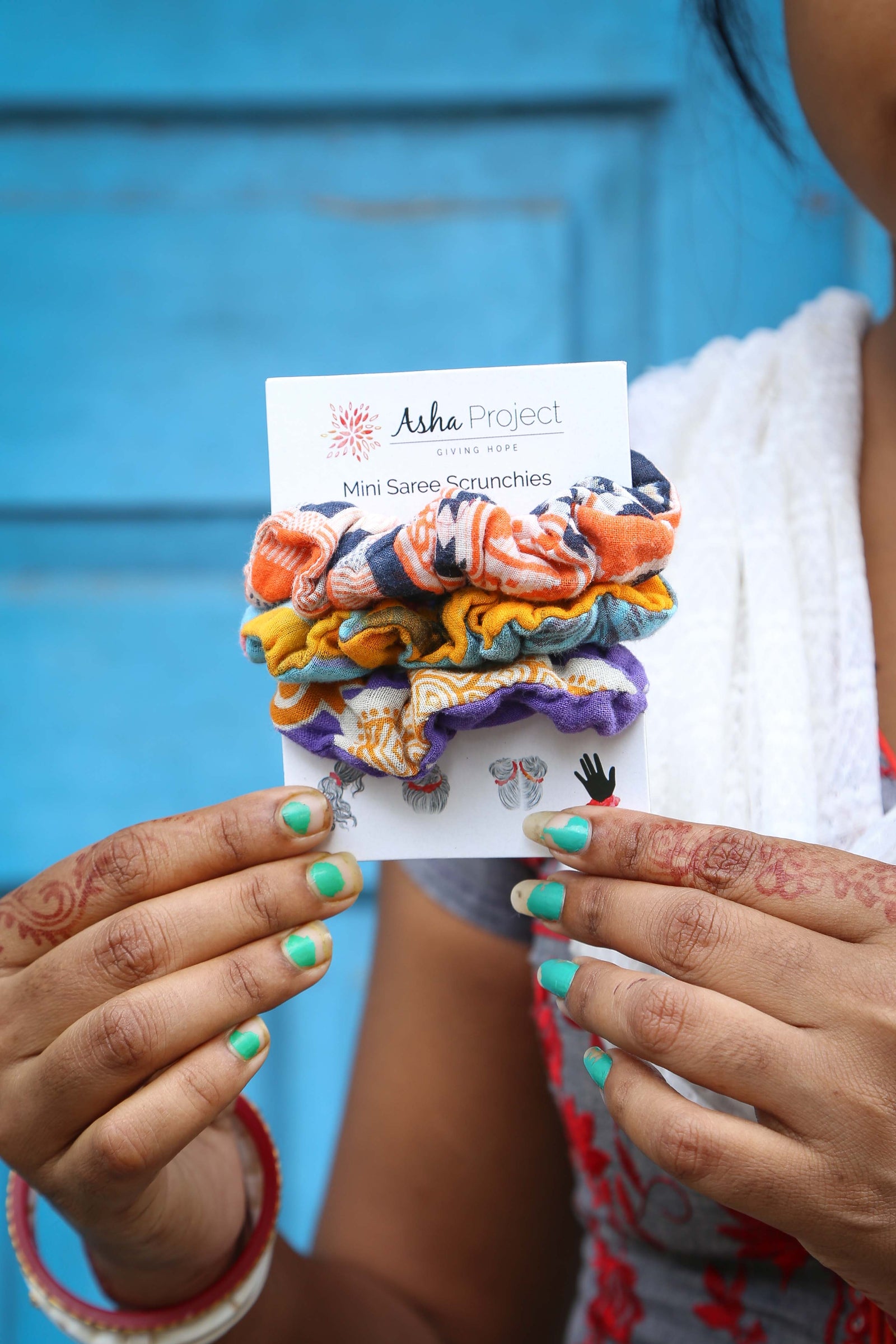 Handmade mini saree scrunchies featuring vibrant fabric patterns, perfect for adding a colorful and stylish touch to your hair while keeping it secure.