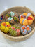 a basket filled with different colored balls of yarn