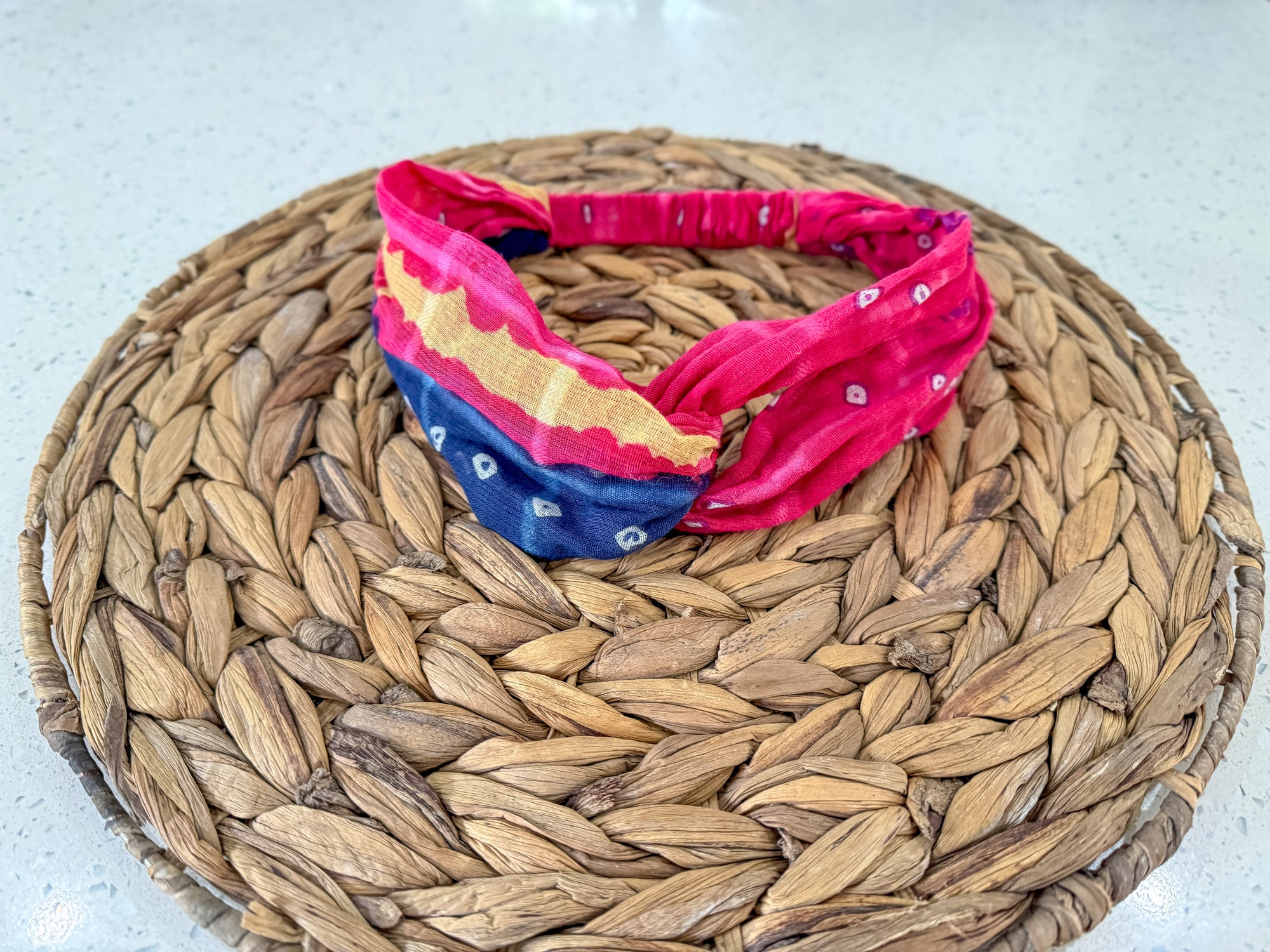 a red, white and blue headband sitting on top of a woven basket