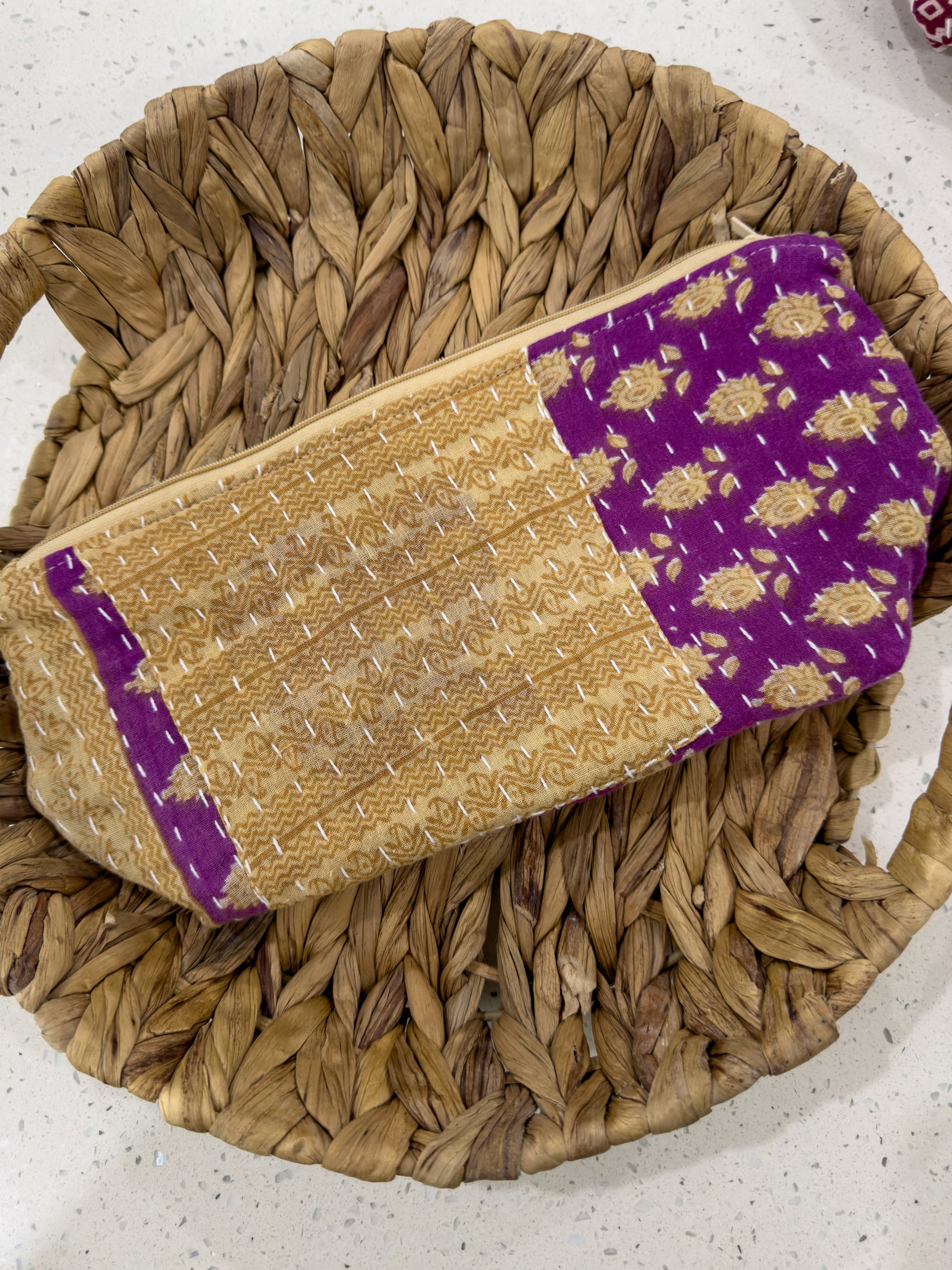 a woven purse sitting on top of a woven basket
