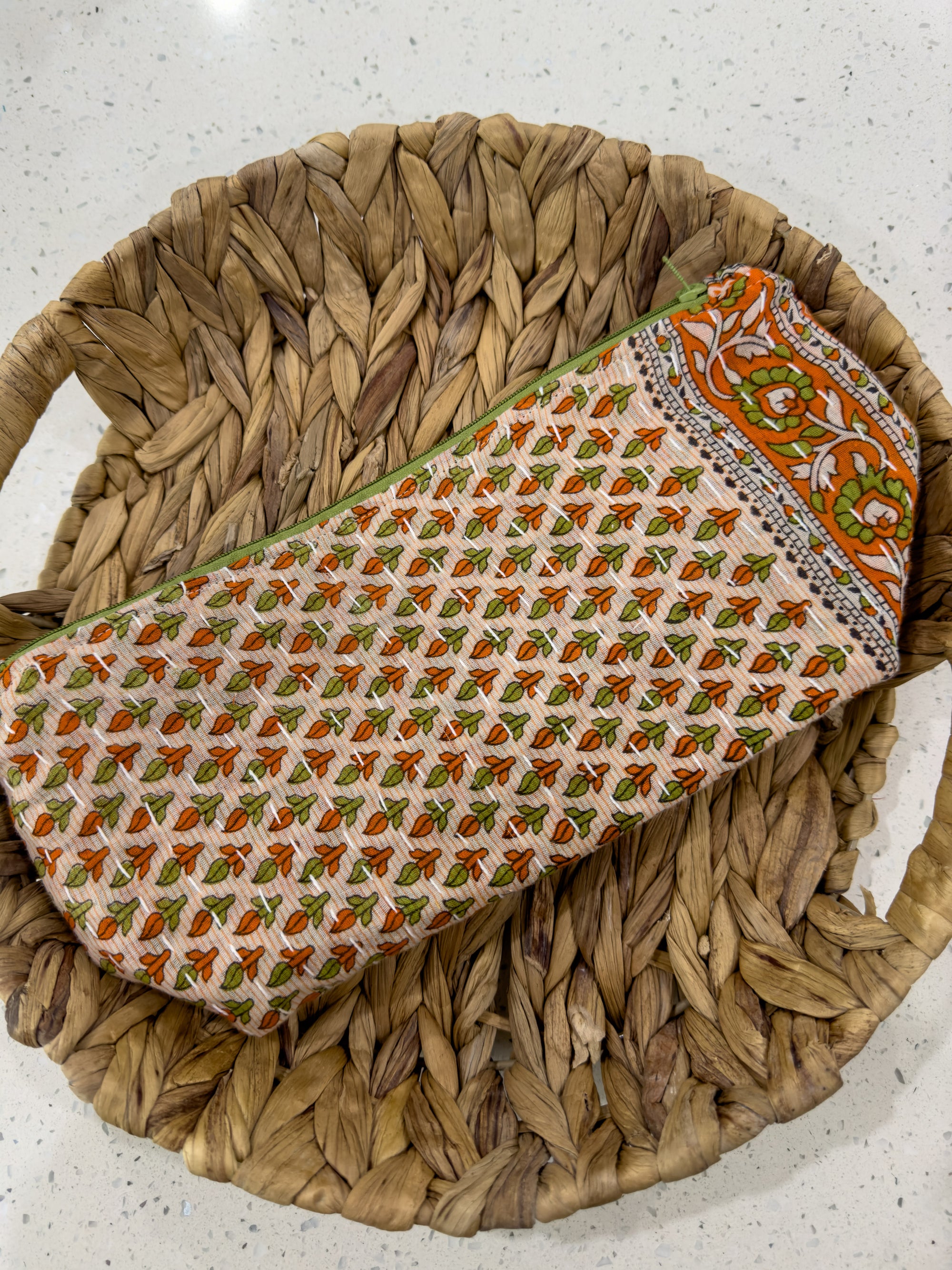 an orange and green tie sitting on top of a woven basket