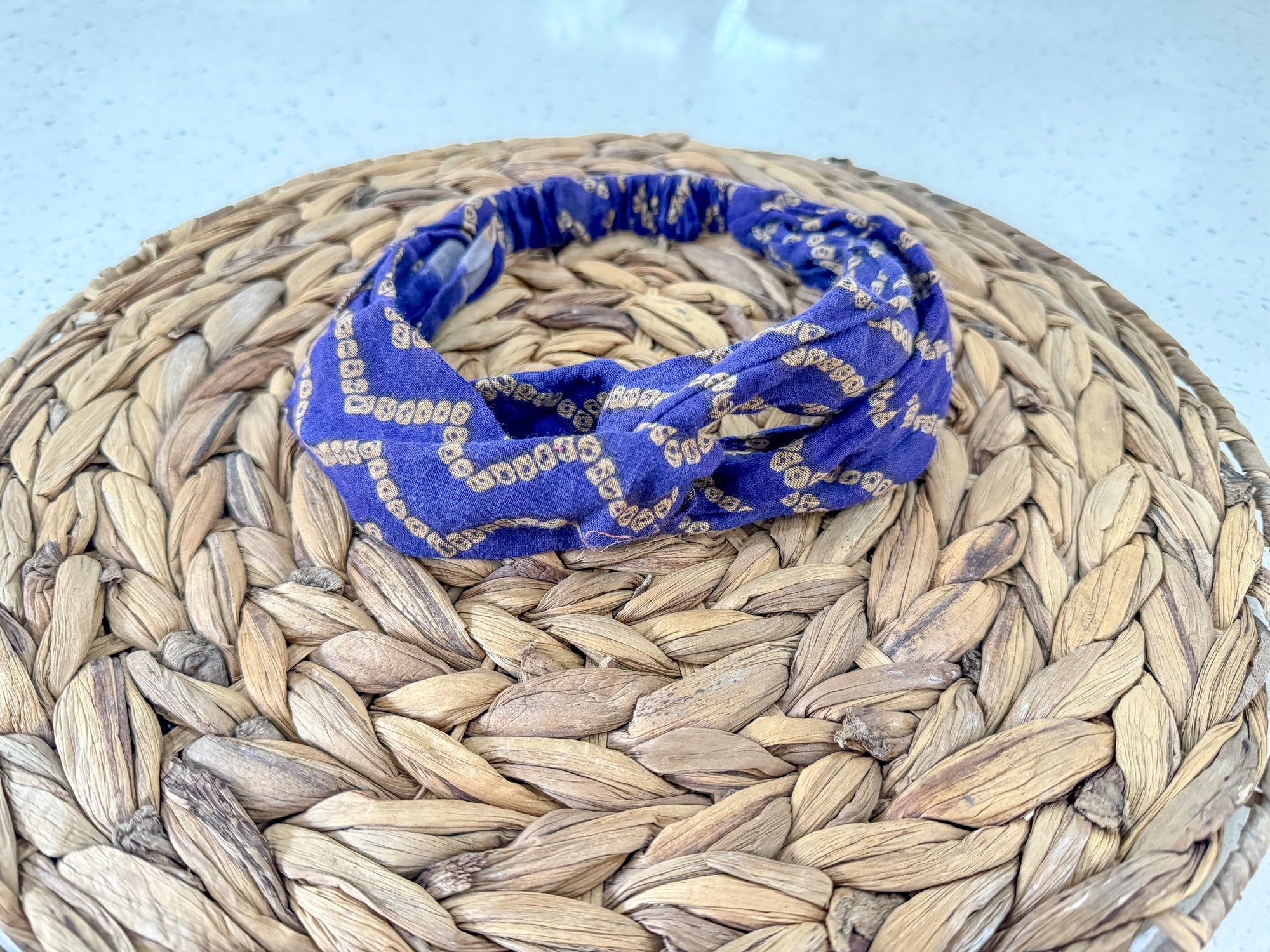 a blue bandanna sitting on top of a woven basket