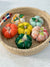 a basket filled with small pumpkins sitting on top of a table