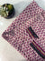 a close up of a cloth on a table next to a potted plant