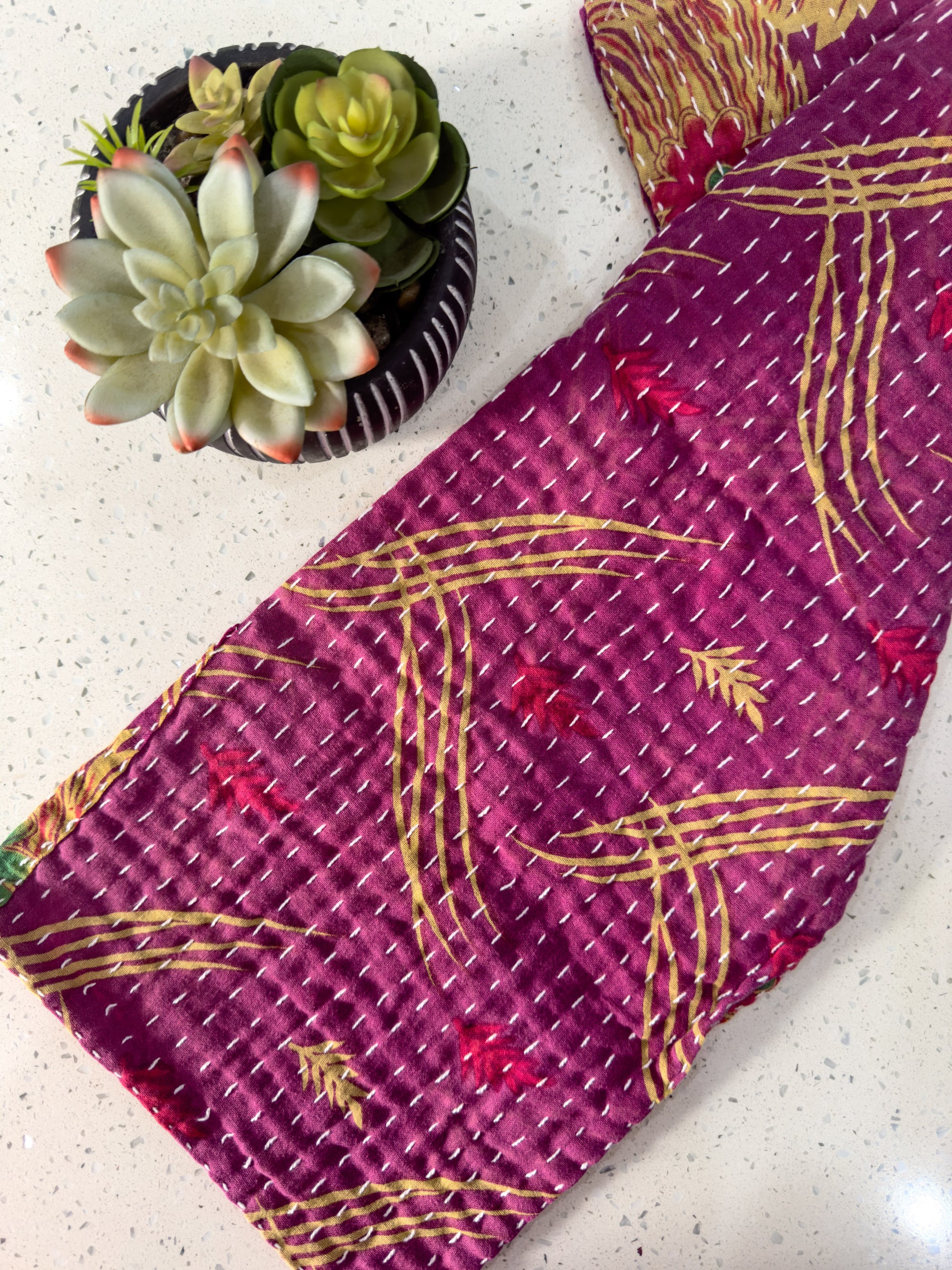 a close up of a tie on a table near a potted plant